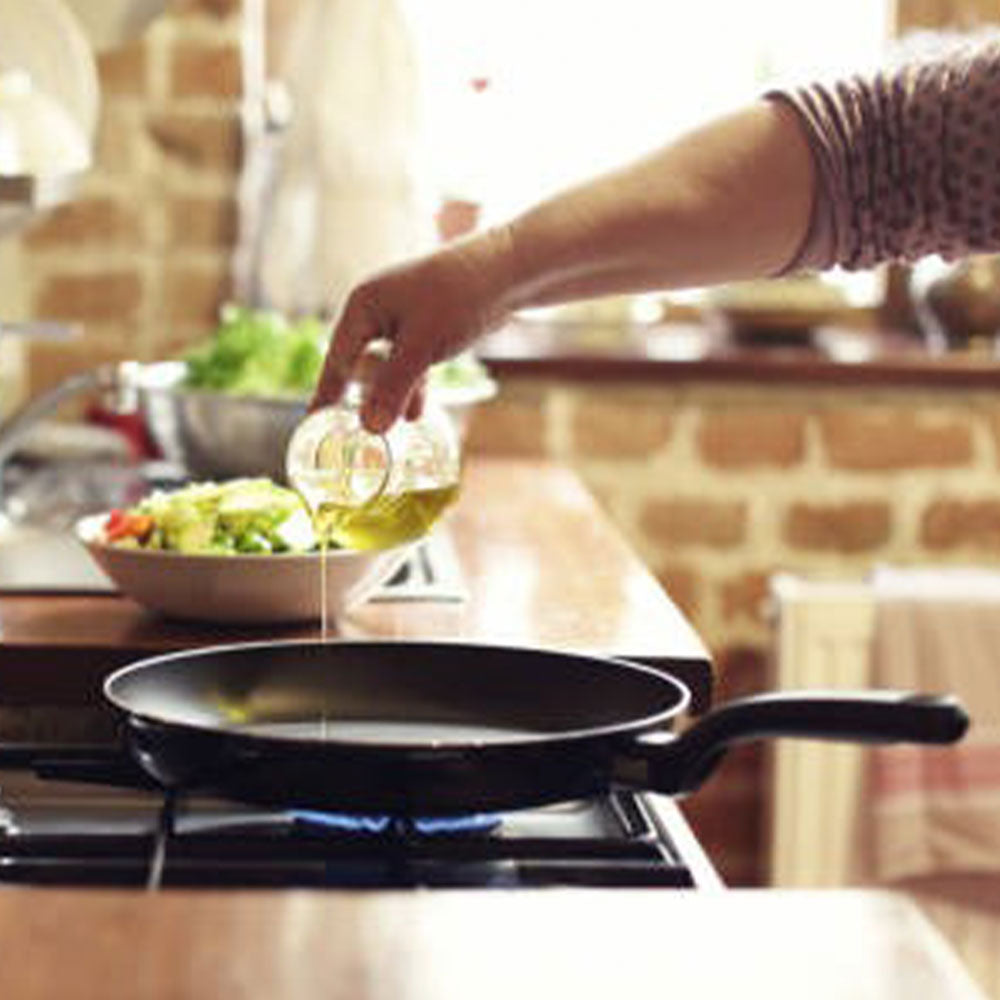 oil being poured in the skillet
